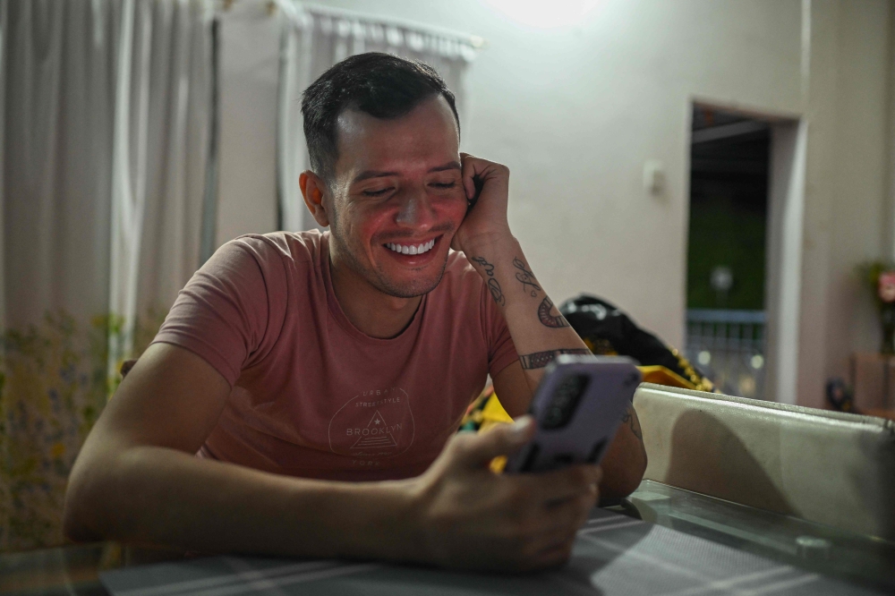 Venezuelan stylist Andry Hernandez Romero, 33, a migrant repatriated from a prison in El Salvador, speaks during a video call at his home in Capacho village, Tachira state, Venezuela on July 24, 2025. — AFP pic
