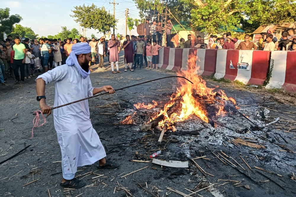 Men exhumed and burned Nurul Haque’s shrouded corpse through a street in Rajbari district on September 6, 2025. — AFP pic 
