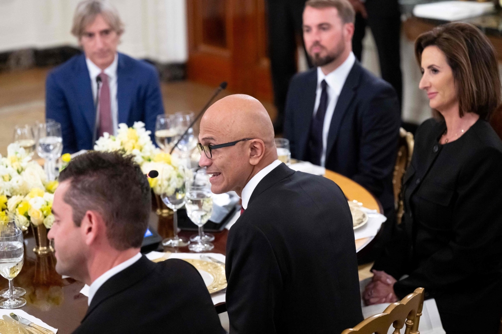 Microsoft CEO Satya Nadella (centre) attends a dinner hosted by US President Donald Trump with tech leaders in the State Dining Room of the White House in Washington, DC, on September 4, 2025. — AFP pic