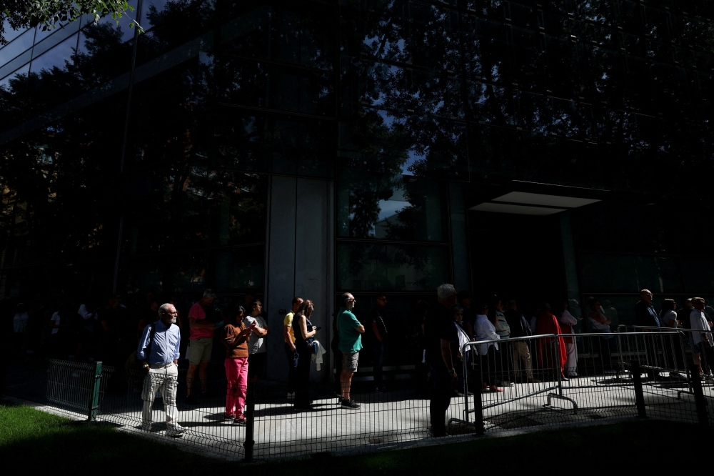 People queue outside the Armani/Teatro to pay tribute as designer Giorgio Armani lies in state, following his death at the age of 91, in Milan September 6, 2025. — Reuters pic