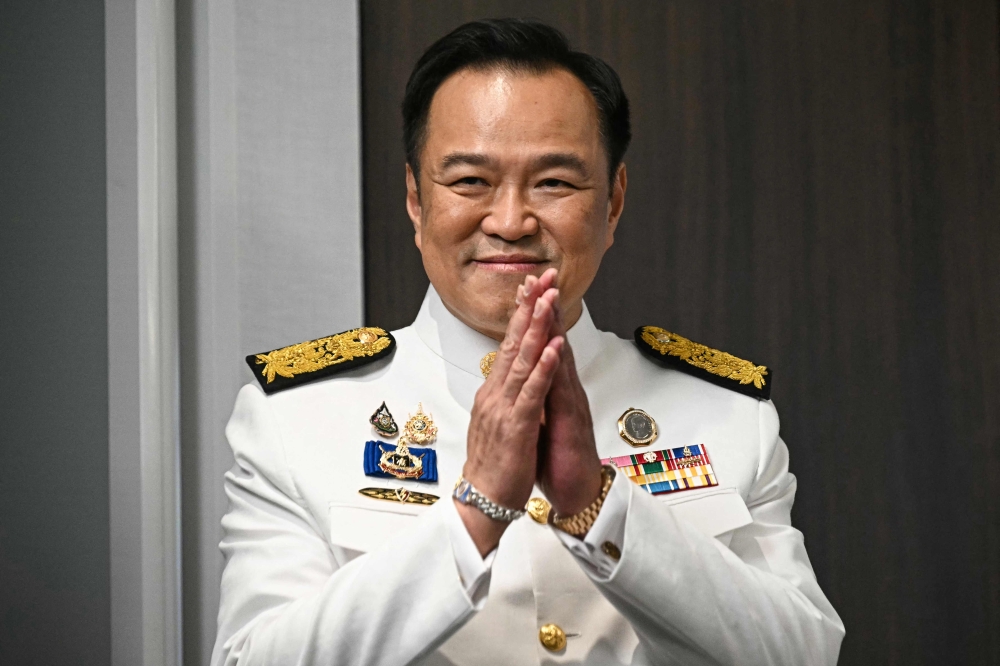 Thailand's new prime minister Anutin Charnvirakul greets media representatives as he arrives to deliver remarks after the royal endorsement ceremony, at the Bhumjaithai Party's headquarters in Bangkok September 7, 2025. Thai tycoon Anutin Charnvirakul took office as prime minister today, after an endorsement from the king started the conservative's tenure as the nation's new leader. — AFP pic 