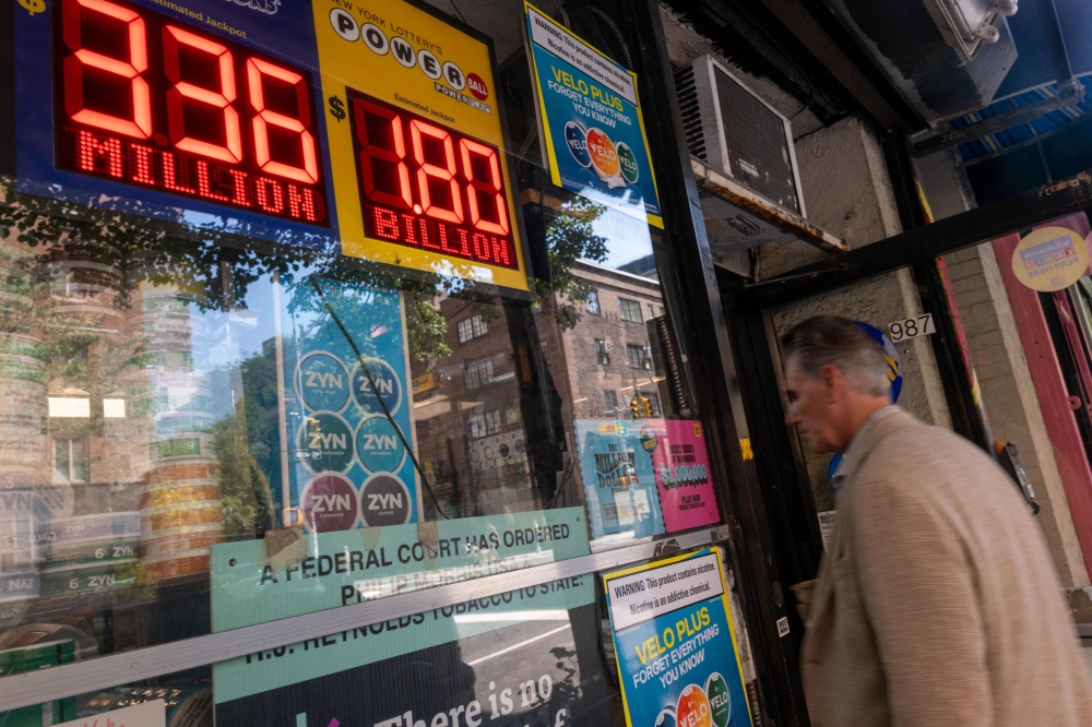 A newsstand in Manhattan advertises the latest Powerball Jackpot, now reaching US$1.8 billion, on September 5, 2025, in New York City. — Spencer Platt/Getty Images North America/Getty Images via AFP