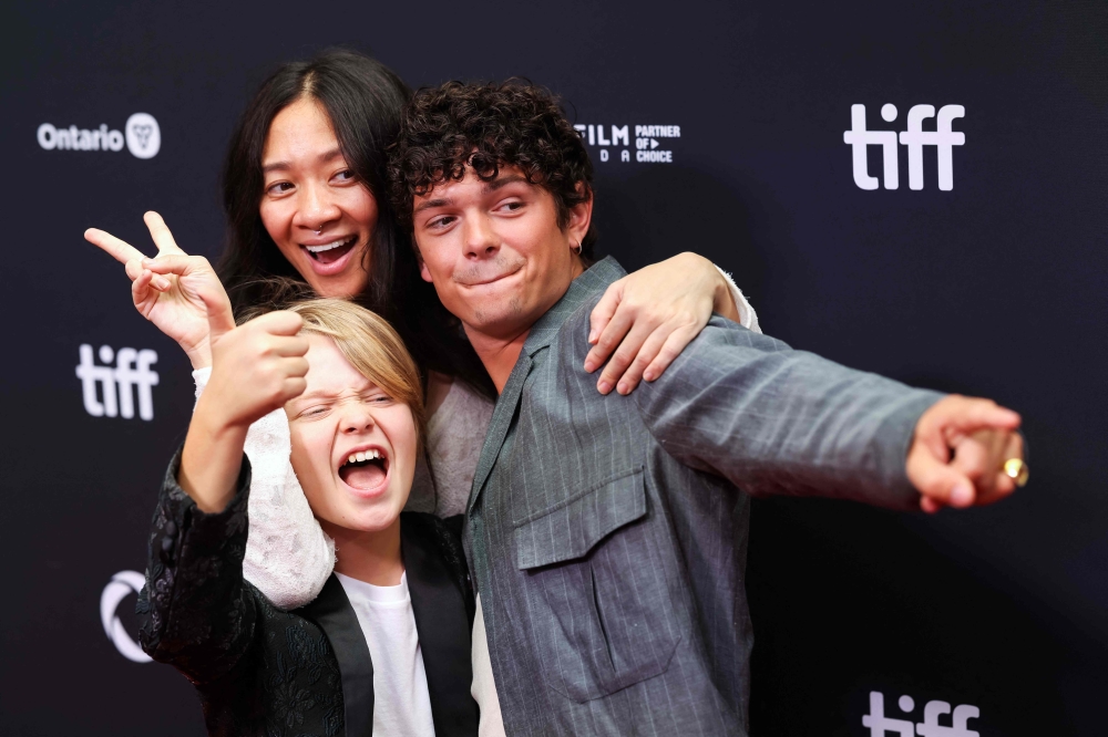 Chinese filmmaker Chloe Zhao (centre) poses with brothers and British actors Jacobi Jupe and Noah Jupe during the premiere of ‘Hamnet’ at the Princess of Whales theatre at the Toronto International Film Festival (TIFF) in Toronto, Ontario, Canada, on September 7, 2025. — AFP pic 