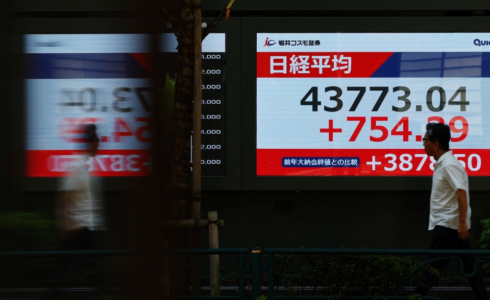 A man walks past a stock quotation board showing the Nikkei share average outside a brokerage in Tokyo, Japan, September 8, 2025. — Reuters pic 