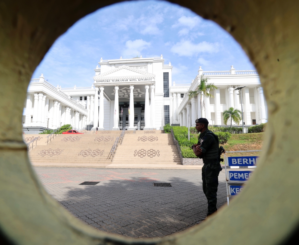Police stand guard outside the Kota Kinabalu Court Complex during the inquest into the death of Form One student Zara Qairina Mahathir September 3, 2025. — Bernama pic