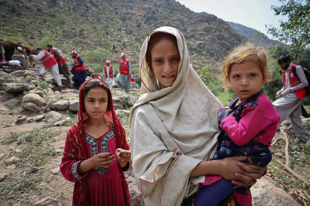 Afghan girls stand near their damaged house following a deadly magnitude-6 earthquake that struck Afghanistan on Sunday, at Lulam village, in Nurgal district, Kunar province, Afghanistan, September 3, 2025. — Reuters pic