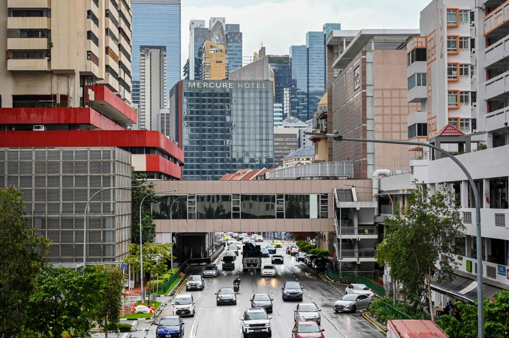 Singapore will reportedly extend two key schemes encouraging the use of cleaner vehicles, with new rebates and surcharges to take effect from 2026. — AFP pic