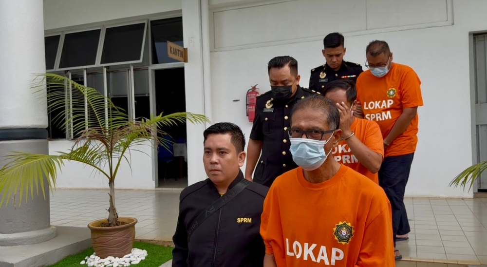 Three out of the five suspects being escorted by Johor Malaysian Anti-Corruption Commission (MACC)  officers after their remand order was granted by Magistrate Rahimah Abd Majid at the Segamat Sessions Court Sept 10, 2025 — Picture courtesy of Johor Malaysian Anti-Corruption Commission (MACC) 