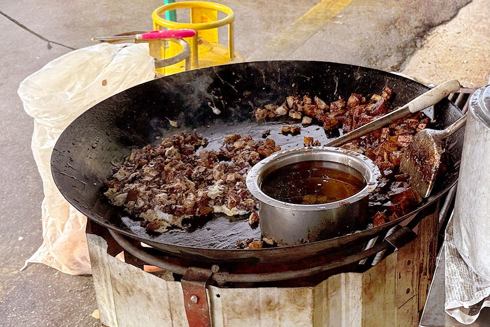 A wide, shallow wok is used, akin to a griddle. — Picture by CK Lim