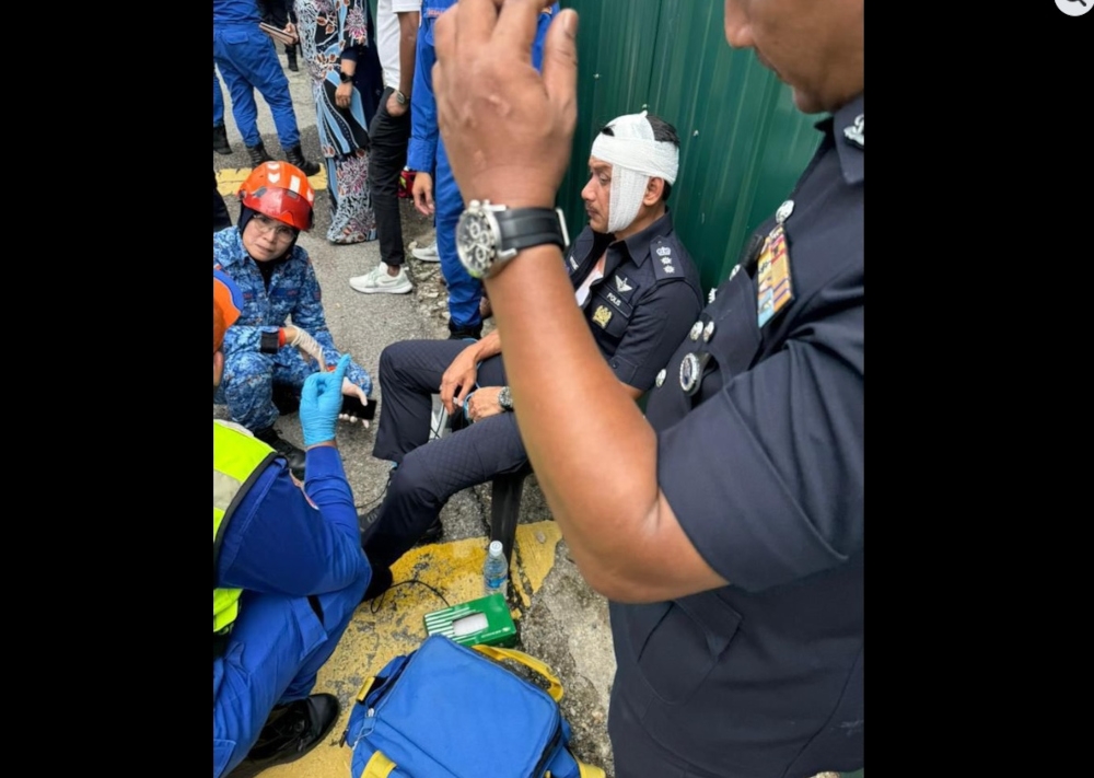 Dang Wangi Police Chief ACP Sulizmie Affendy Sulaiman being attended to by emergency services after the attack in Kampung Sungai Baru, September 11, 2025. — Picture from Facebook/Anwar Ibrahim 
