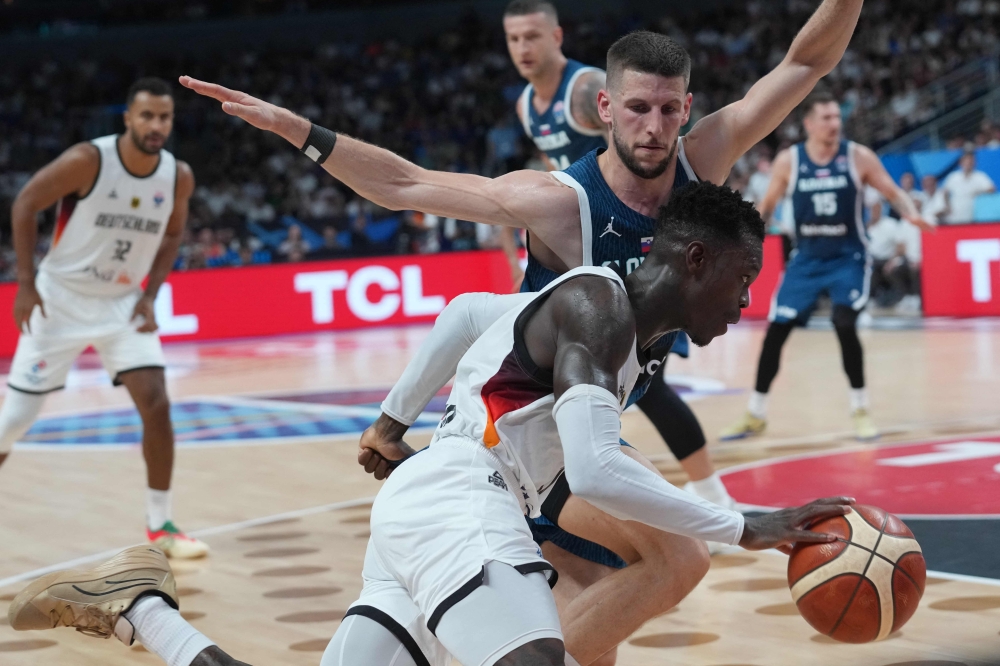 Players from Germany and Slovenia battle for the ball during their EuroBasket 2025 quarter-final in Riga, Latvia, September 10. — AFP pic