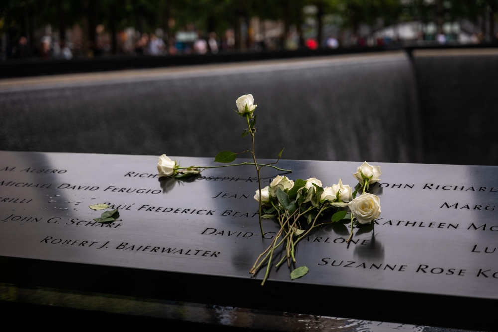 Flowers are placed on victims' names at the National September 11 Memorial & Museum on September 10, 2025 in New York City. — AFP pic