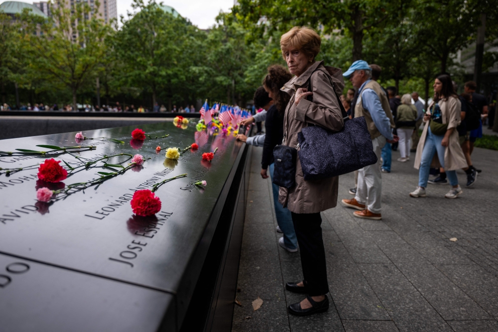 People gather at the National September 11 Memorial & Museum on September 10, 2025 in New York City. — AFP pic