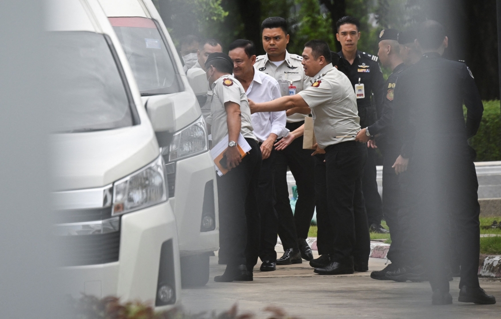 An hour after the court delivered its verdict, Thaksin was placed in a van, escorted by Corrections Department officials, and, following medical checks, transferred to Klong Prem prison. — Reuters pic
