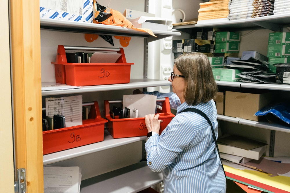 School principal Maria Tallberg stores the smartphones in a secure room where they will stay untill the end of the school day at Kungsvagens skola comprehensive Swedish-speaking school on August 21, 2025 in Sipoo, Finland. — AFP pic