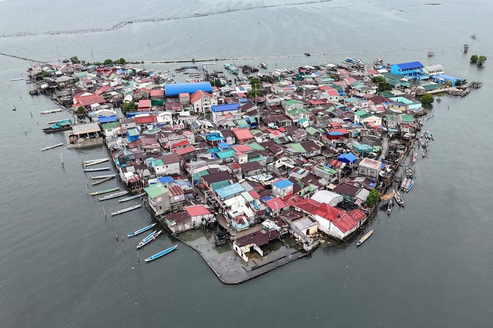 This aerial view taken on July 7, 2025, shows cramped houses on Isla Pugad in Hagonoy town, Bulacan province, north of Manila. Sea levels across the Philippines as a whole are rising three times faster than the global average of 3.6 millimeters per year, and the Department of Environment and Natural Resources (DENR) has said this could accelerate to 13 millimeters annually. — AFP pic 