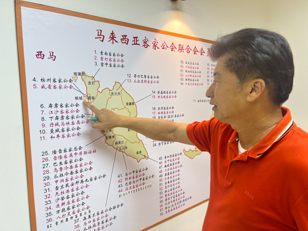 Penang Hakka Association chairman Datuk Pang Yun Tiam showing a map of all the Hakka Associations in Malaysia. — Picture by Opalyn Mok