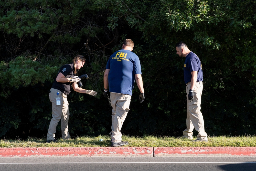 Members of the FBI forensics team work in a wooded area in Orem, Utah, on September 11, 2025, near the suspected escape route of the shooter who fatally shot U.S. activist Charlie Kirk. — Reuters pic