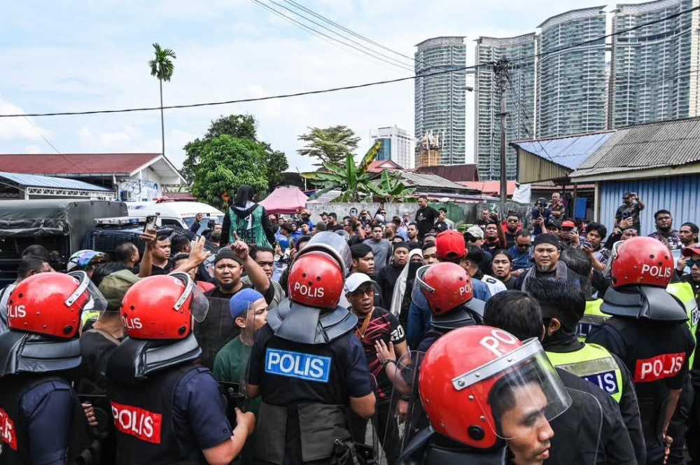 Tensions flared yesterday in Kampung Sungai Baru during a court-ordered eviction exercise. — Picture via Facebook