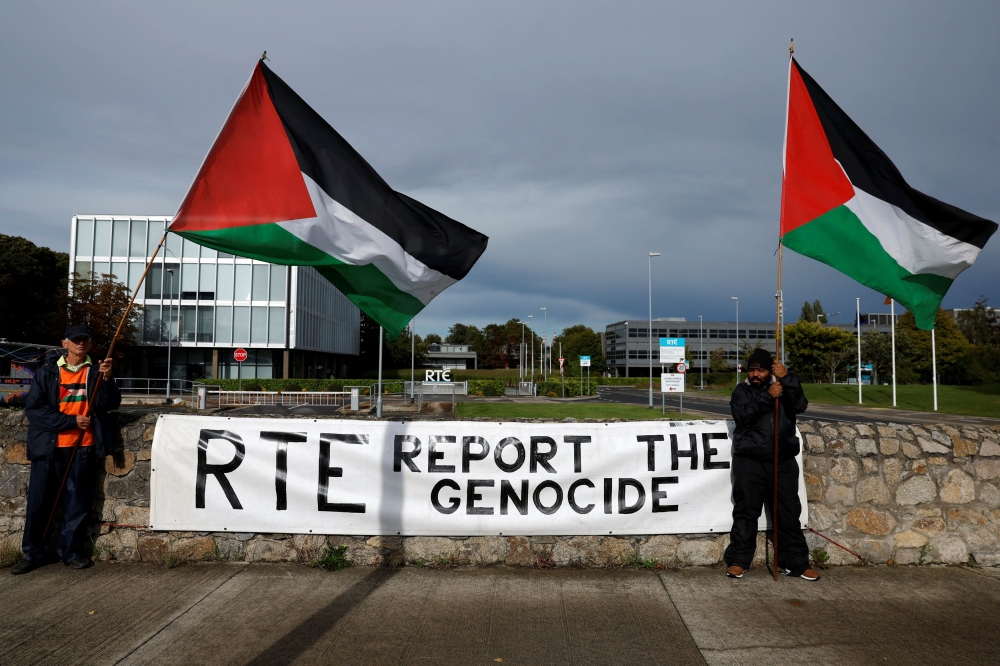 Pro-Palestinian protestors hold flags and a sign outside the RTE (Radio Telefis Eireann) Irish public service broadcaster television studios, in Dublin, Ireland September 11, 2025. — Reuters pic