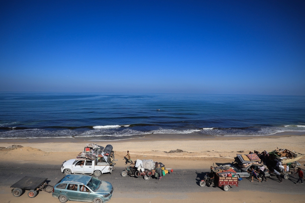 Palestinians transport their belongings as they evacuate Gaza City towards southern areas of the coastal Gaza Strip, on September 11, 2025. — AFP pic