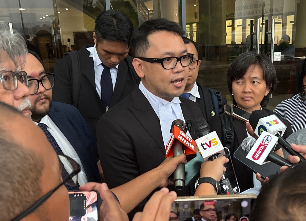 Lawyers Azhier Farhan (centre), Datuk Ram Singh (left) and Joan Goh (right) representing four out of five students at SMKA Tun Datu Mustapha in Papar who have been charged with bullying Zara Qairina, speak to reporters after the inquest at the Coroner’s Court in Kota Kinabalu, Sabah on September 12, 2025. 