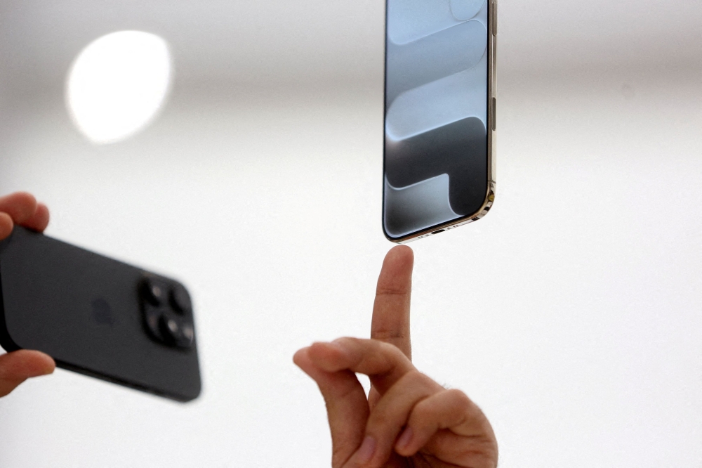 A person points to an iPhone during Apple’s event at the Steve Jobs Theatre on its campus in Cupertino, California, September 9, 2025. — Reuters pic