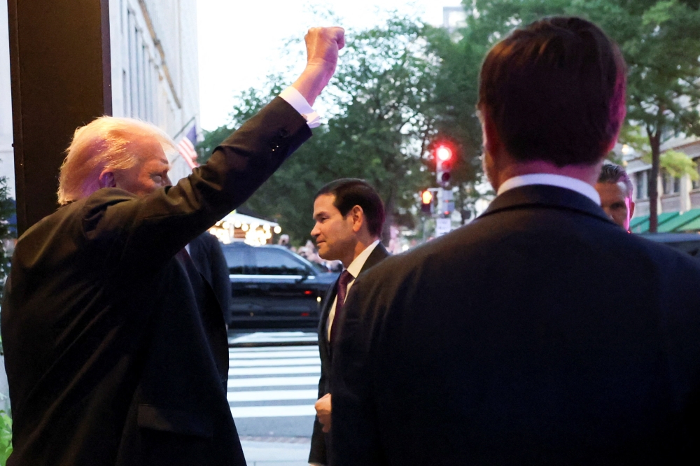 US President Donald Trump gestures as he and US Vice President JD Vance, Secretary of State Marco Rubio and Defence Secretary Pete Hegseth arrive at Joe’s Seafood restaurant near the White House for dinner, in Washington September 9, 2025. — Reuters pic