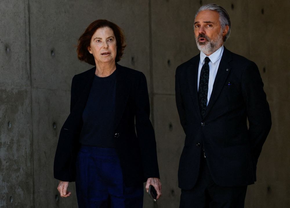 In this file photo taken on September 7, 2025, Silvana Armani and Andrea Camerana, the niece and nephew of the late designer Giorgio Armani, walk outside the Armani/Teatro as he lies in state in Milan, Italy. — Reuters pic