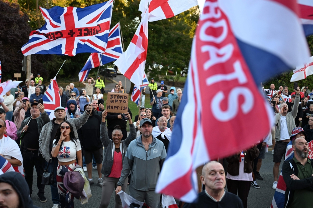 Protesters, calling for the closure of The Bell Hotel which houses asylum seekers, gather outside the council offices in Epping August 31, 2025. — AFP pic