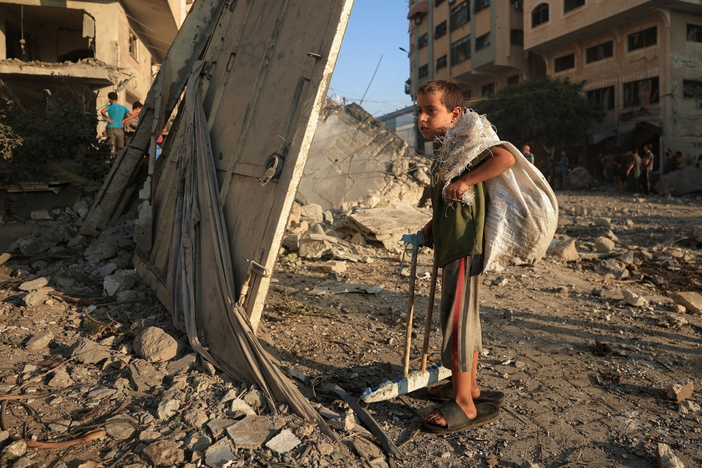 A Palestinian boy stands near a house that was destroyed in an overnight Israeli air strike, in Gaza City, September 13, 2025. — Reuters pic