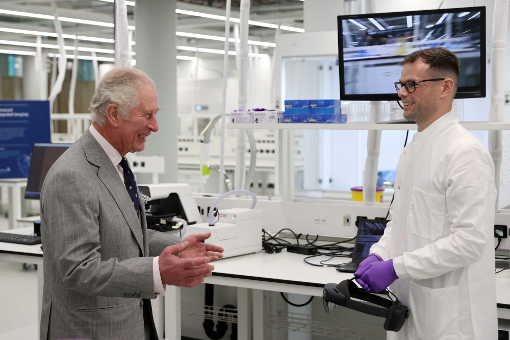 Britain’s King Charles gets a demonstration of how augmented reality helps with HoloLens technology during a visit to AstraZeneca’s global R&D facility at the Cambridge Biomedical Campus in Cambridge November 23, 2021. — Chris Jackson/Pool via Reuters