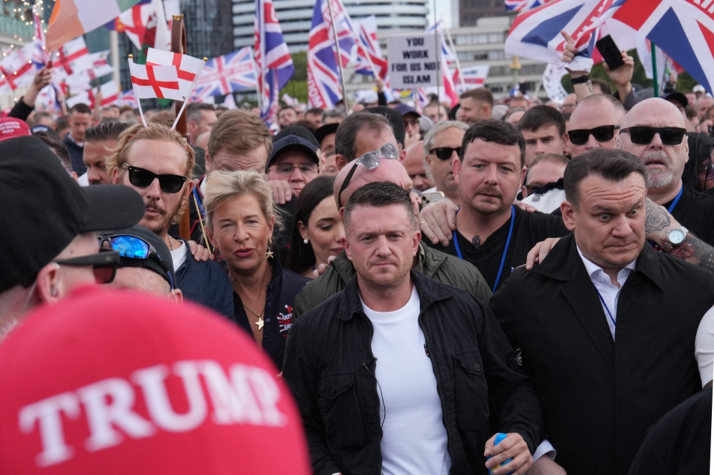 British far-right activist Tommy Robinson gestures as he marches with supporters, including Katie Hopkins and Laurence Fox, during a “Free speech” march in central London on September 13, 2025. — AFP pic