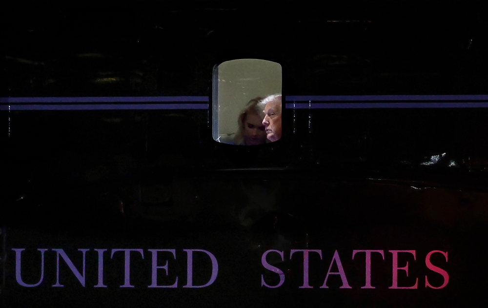 US President Donald Trump looks out of a window on Marine One as he departs from the Wall Street Landing Zone in New York September 12, 2025. — AFP pic