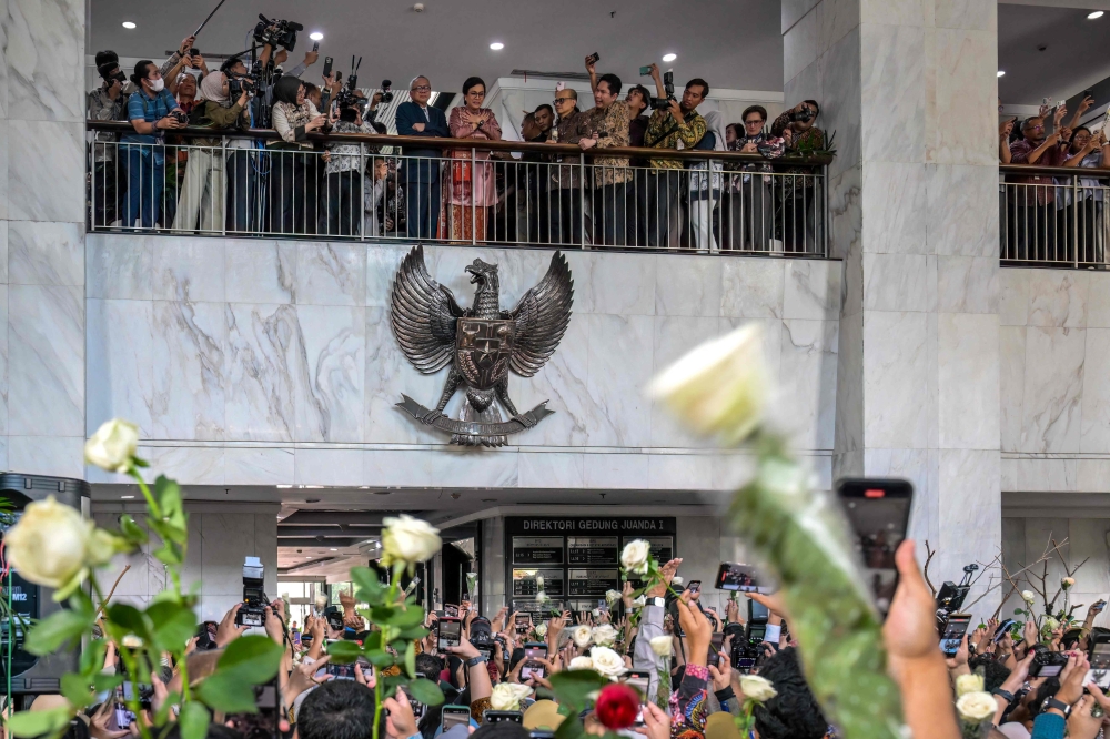 Former Indonesian Finance Minister Sri Mulyani Indrawati gestures to finance ministry staff after a handover ceremony to her successor in Jakarta on September 9, 2025. — AFP pic