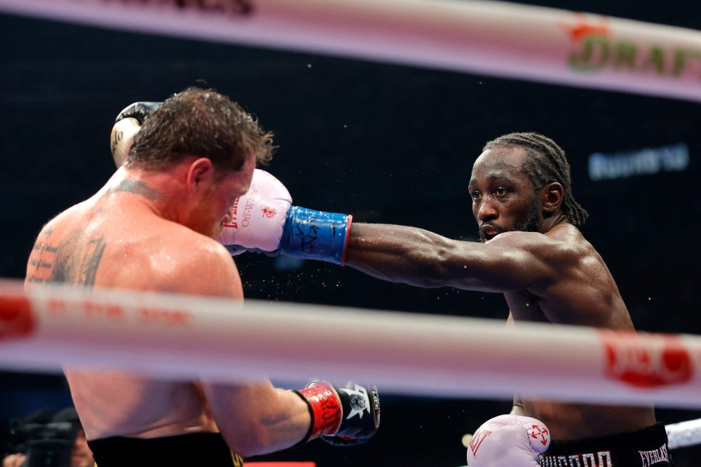 Terence Crawford lands a left on Canelo Alvarez in their undisputed super middleweight title fight at Allegiant Stadium in Las Vegas on September 13, 2025. — AFP pic