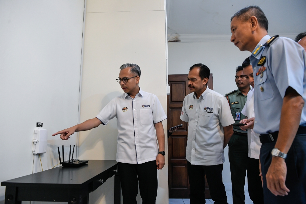 Communications Minister Datuk Fahmi Fadzil and Butterworth Air Base Commander Brigadier General Tan Lai Hock (right) visit the Fibre-to-the-Home (FTTH) project at the Armed Forces Family Housing in Butterworth September 14, 2025. — Bernama pic