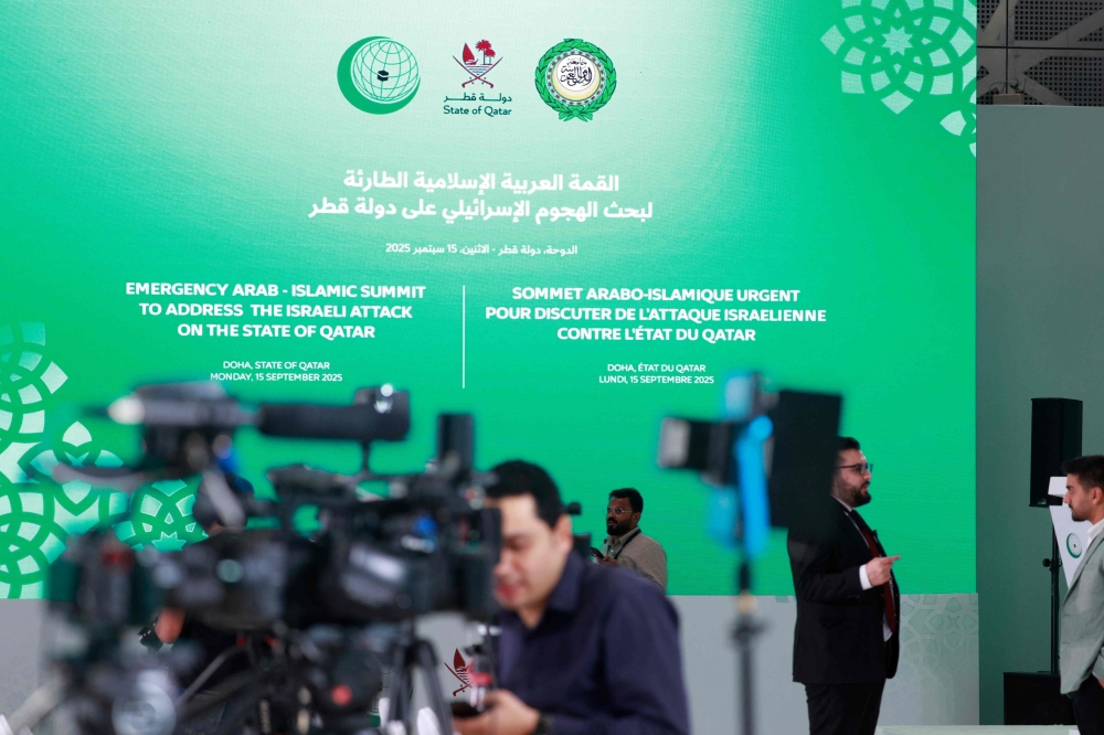 Members of the media gather at the press room reserved for the coverage of the upcoming Arab-Islamic summit, organised to discuss the recent Israeli attack on Qatar, in Doha September 14, 2025. — AFP pic 