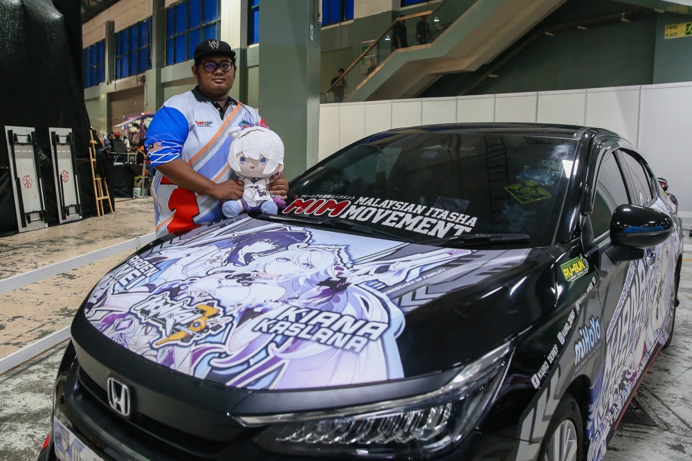 Muhammad Zulfiqar posing with his itasha during AniManGaki 2025. — Picture by Yusof Isa