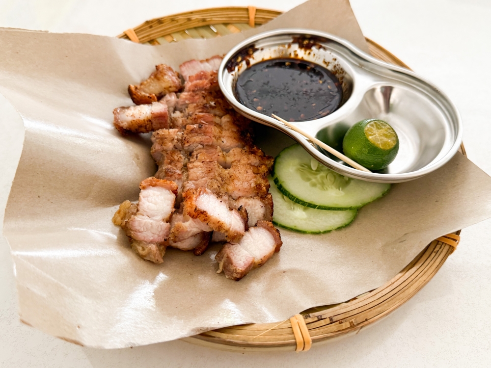 Babi 3 Layer Bakar is delicious dipped in the dark soy sauce zapped with the zing from a squeeze of the calamansi lime. — Picture by Lee Khang Yi