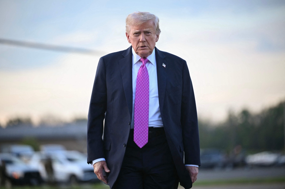 US President Donald Trump walks to board Air Force One at Morristown Municipal Airport in New Jersey on September 14, 2025, after spending the weekend at his Bedminster residence. — AFP pic