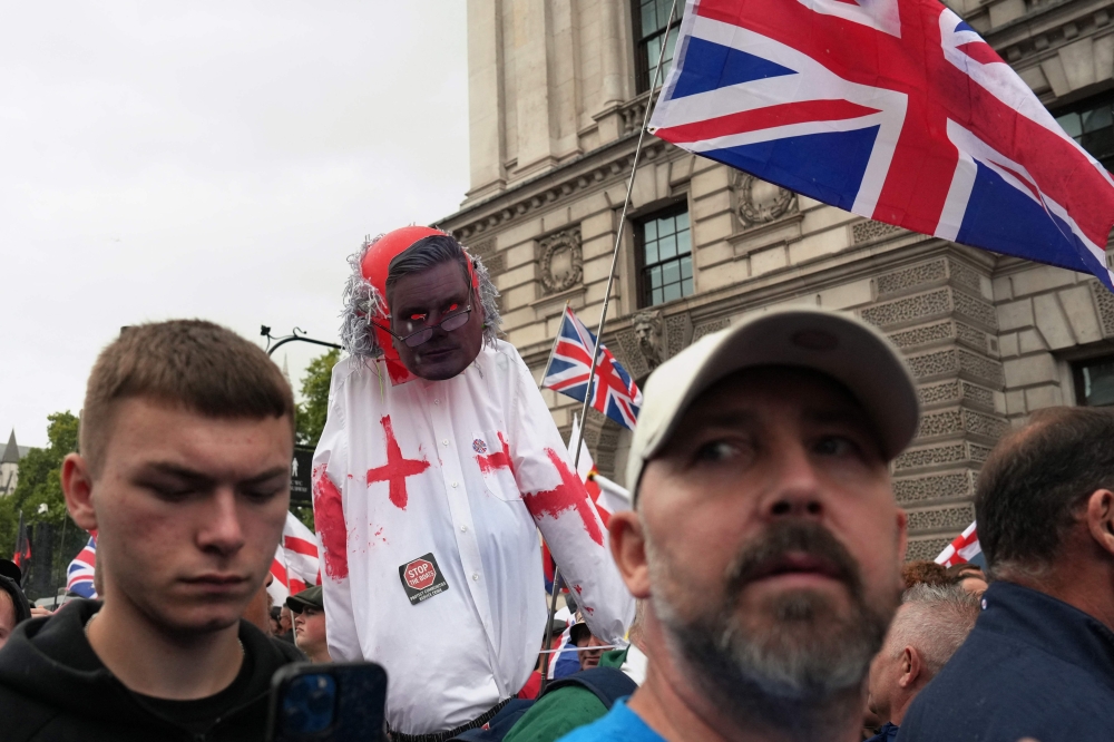 Supporters of British far-right activist Tommy Robinson, whose real name is Stephen Yaxley-Lennon, carry an effigy wearing a mask of Prime Minister Keir Starmer during a ‘Free Speech’ march in central London on September 13, 2025. — AFP pic