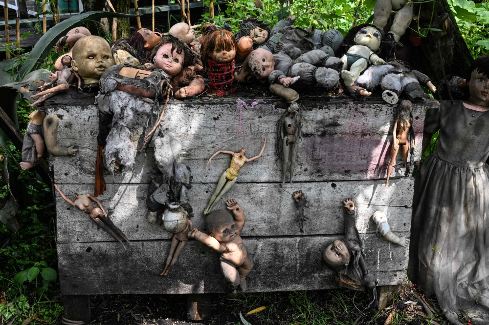 Old and deteriorated dolls set on a box at Isla de las Munecas (Island of the Dolls) in Xochimilco, Mexico on September 10, 2025. — AFP pic