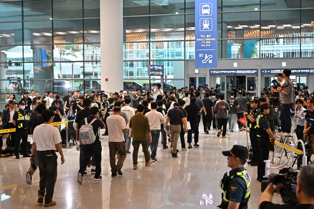 South Korean workers arrive at Incheon International Airport in Incheon on September 12, 2025, after the touch down of a specially chartered Korean Air Boeing 747-81 (KE9036) bringing hundreds of South Korean workers back from Atlanta after their detention in a US immigration raid at a Hyundai-LG plant in Ellabell, Georgia. — AFP pic