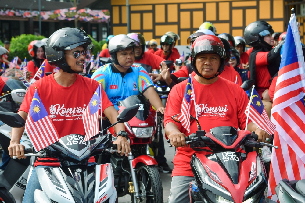 Participants of the Malaysia Day Motorcycle Convoy gather before flag-off at Taman Warisan Kampung Laut today. A total of 120 motorcycles from the Tumpat Madani Community rode 71 kilometres while waving the Jalur Gemilang to instil patriotism. — Bernama pic