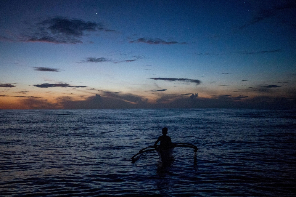 A Filipino fisheman rows a boat during a trip near the disputed Scarborough Shoal, in Masinloc, Zambales province, Philippines, July 18, 2022. — Reuters pic