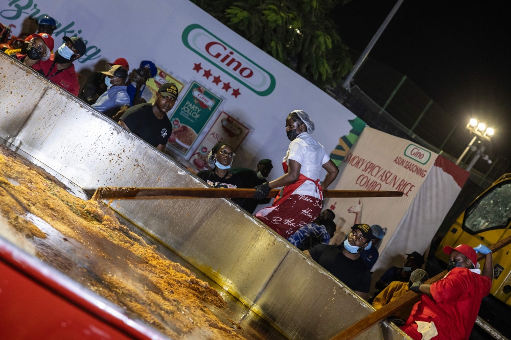 Nigerian chef Hilda Baci (left) stirs rice in a giant pot during an attempt to break the world record for the largest pot of Jollof rice, led by Nigerian chef Hilda Baci in Lagos September 12, 2025. — AFP pic 