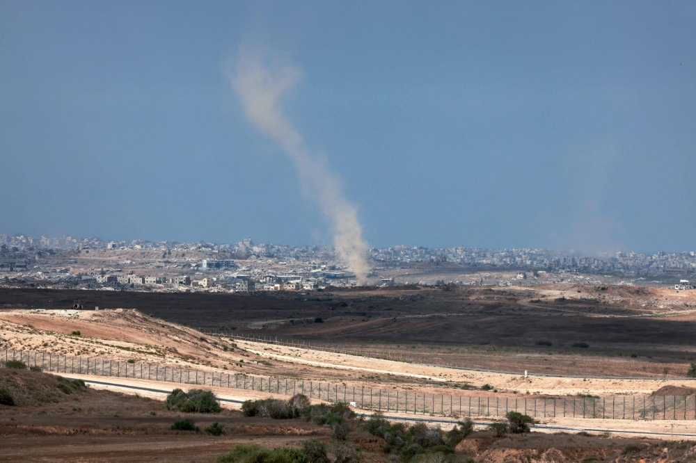 This picture taken from a position at Israel's border with the Gaza Strip shows smoke billowing amid Israeli bombardment of the besieged Palestinian territory today. — AFP pic 