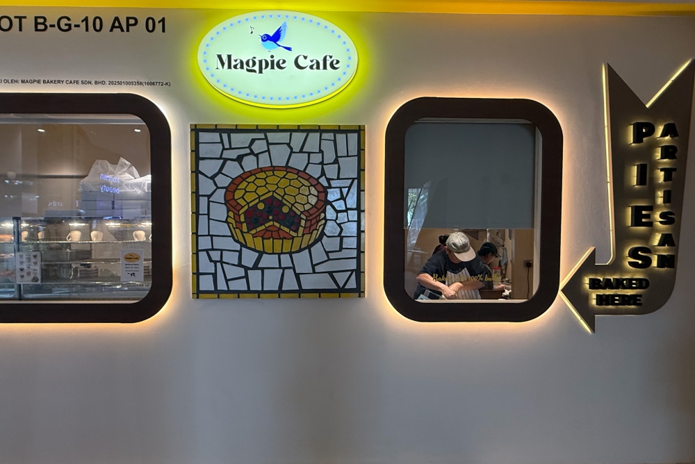 Peek inside the window for a view of the kitchen working hard to bake the pies. — Picture by Lee Khang Yi