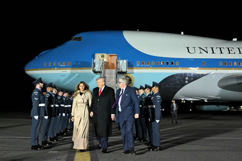 US President Donald Trump (centre) and US First Lady Melania Trump disembark from Air Force One after landing at Stansted Airport, eastern England, on September 16, 2025, on the first day of a two-day visit to the UK. US President Donald Trump arrived in the UK late Tuesday for a State Visit with his wife, Melania, a rare privilege made at the invitation of King Charles III. — AFP pic